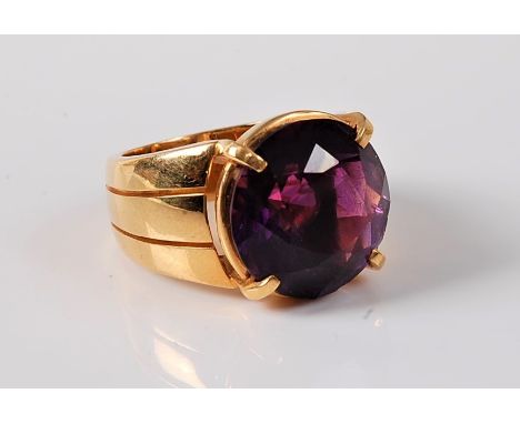 An amethyst dress ring, the round amethyst, approx. 14.8mm diameter, in a four claw mount set to a broad tapered band, all in
