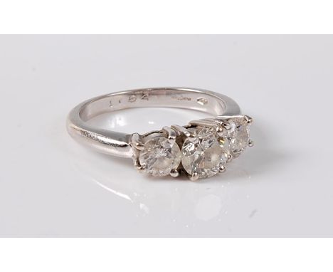 An 18ct three stone diamond ring, the three graduated round brilliant cut diamonds, total estimated approx. 1.84cts, all claw