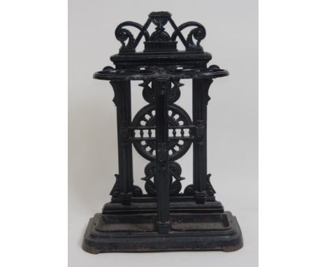 A Victorian cast iron and black enamelled stick stand in the manner of Coalbrookdale, having twin drip-trays and openwork bac