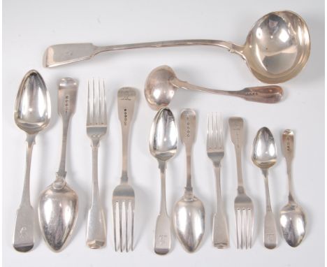 An early 19th century silver harlequin cutlery suite, in the Fiddle pattern with crested terminals, comprising twelve dessert