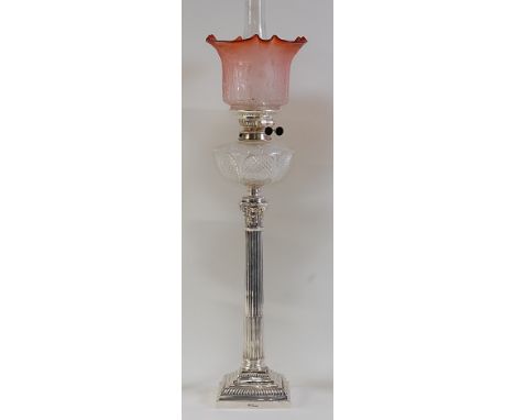 An Edwardian silver Corinthian column table lamp by Mappin & Webb, having cranberry acid etched shade over hobnail cut clear 