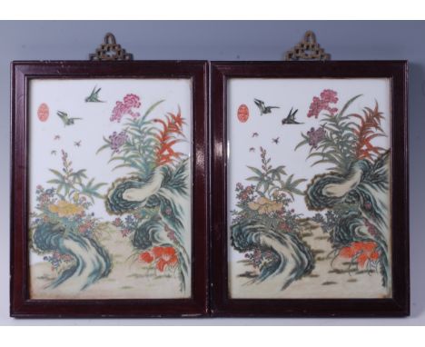 A pair of Chinese enamel decorated porcelain panels, depicting birds flying over flowers and foliage, each signed upper left,