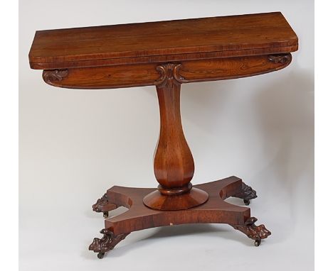 An early Victorian rosewood pedestal card table, the fold-over top having swivel action, opening to reveal baize lined playin