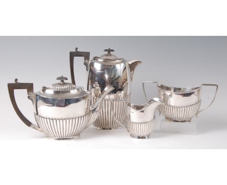 An Edwardian large silver four-piece tea and coffee service, comprising teapot, coffee pot, twin handled sugar and cream, eac