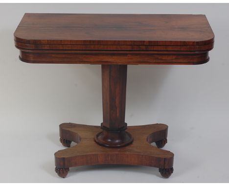 A William IV rosewood card table, the D-shaped fold-over top revealing baize lined playing surface, on an octagonal turned co