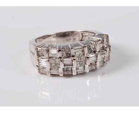 A diamond dress ring, the three stepped rows, each comprising of alternating groups of four princess cut diamonds and two bag