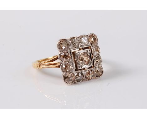 A diamond plaque ring, the central old brilliant cut diamond in a bead and squared millegrain mount, surrounded by old brilli