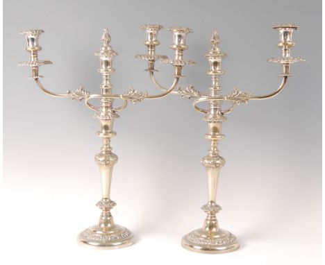 A pair of early 20th century silver *plate* three-light candelabra, in the 18th century style, the knopped centre column with