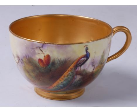 A Worcester porcelain teacup, decorated with a peacock upon a branch, signed R. Austin, gilt-washed interior, puce mark, 8.5c