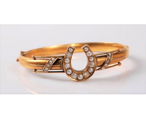 A diamond and pearl horseshoe bangle, the horseshoe set with  six old European cut diamonds and slightly graduated alternatin