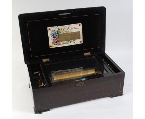 A late 19th century Swiss rosewood cased music box, the rosewood case inlaid with sporting scene, opening a 9¼" cylinder, pla