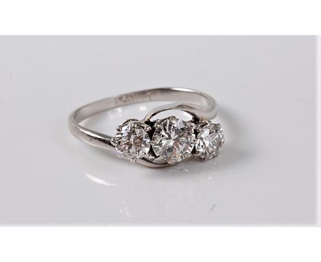 A three stone diamond crossover ring, the graduated round brilliant cut diamonds weighing approx. 1.45cts, all claw mounted t