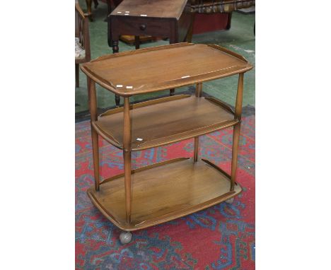 An Ercol light oak three tier tea trolley.