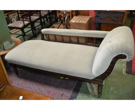 A Victorian  mahogany chaise, scrolling arm, spindled back stuffed overseat, turned legs, ceramic casters, c.1870