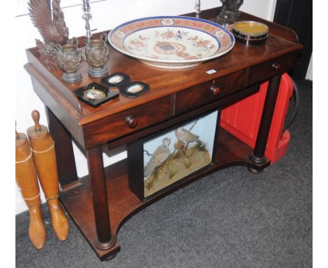 A Victorian mahogany washstand, three quarter galleried top, three drawers to frieze, button handles, spreading cylindrical s