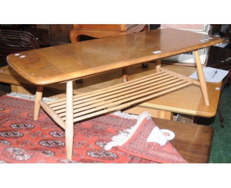 An Ercol coffee table    Condition Report:  Scuffs and scratches throughout, signs of animal attack to leg and undertier side