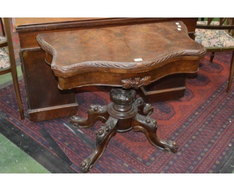 A Victorian figured walnut card table, serpentine fold over top, acanthus carved column, circular socle four carved cabriole 