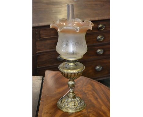 A Victorian brass oil lamp with etched glass shade