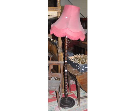 An early 20th Century oak standard lamp