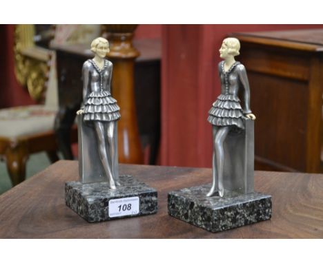 A pair of reproduction Art Deco bookends in the form of young ladies in Raa-Raa skirts, after Lorenzl,    Condition Report:  