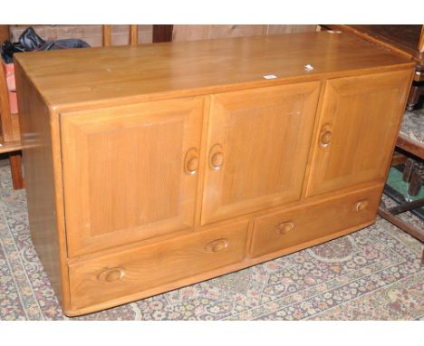 An Ercol sideboard, three door cupboard over two long drawers.   Condition Report:  Some scratches and bruises, see images, d