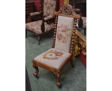 A Victorian Gothic revival oak nursing chair, carved, pierced and finialed top rail, Berlin woolwork padded back, bobbin turn