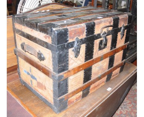 An early 20th century wooden bound travelling trunk
