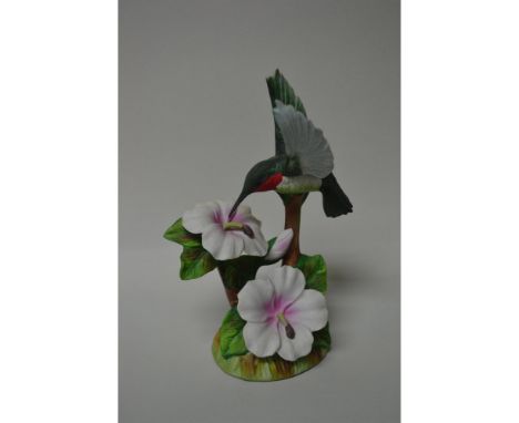 Bisque Porcelain Decorated, A Limited Edition Figurine, Hand Painted and Hand Crafted featuring a delicate Hummingbird in Fli