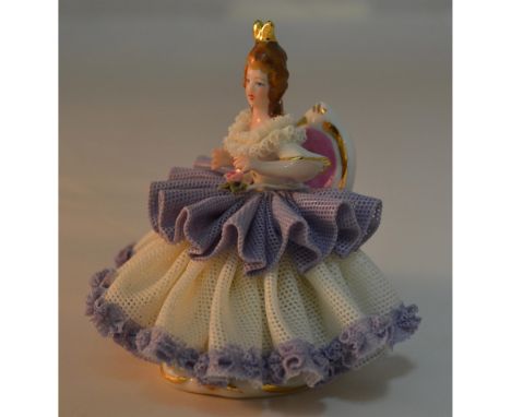 Glazed Porcelain Decorated, hand created, hand painted in fine detail by the Artists of Dresden. Featuring a Lady seated, dre