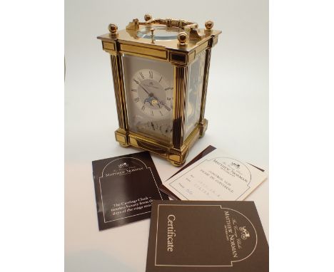 Matthew Norman brass rolling moon carriage clock with original box and certificate serial no 01610N CONDITION REPORT: Some di
