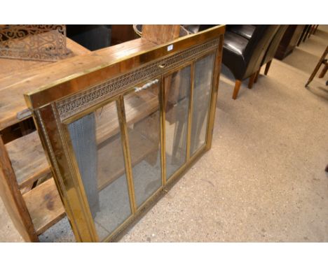 A large brass and glazed firescreen