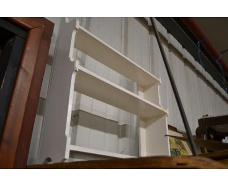 A white painted wall shelf