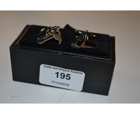 A pair of novelty cufflinks in the form of tools