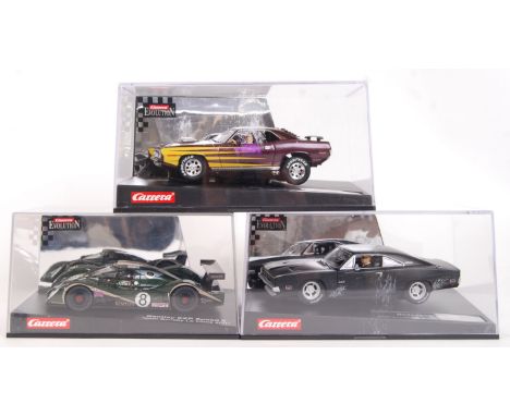 A collection of 3x original contemporary 1/32 scale Carrera Evolution plastic model slot cars to include; 25714 Plymouth 'cud