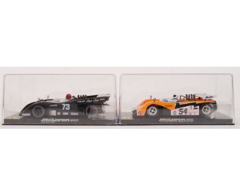 A collection of 2x original contemporary Vanquish MG 1/32 scale plastic slot racing cars to include; CA7 McLaren M8D negro & 