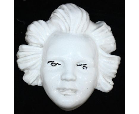 Ashtead Pottery - a rare pottery wall mask modelled in relief as a child's face, white glazed, indistinct marks but believed 