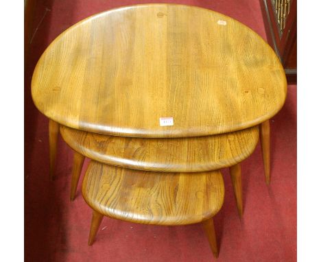 An Ercol light elm nest of three pebble tables, the largest width 65cm Condition Report / Extra Information All appear to hav