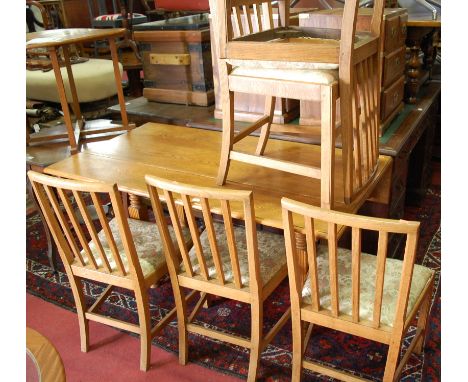 An early 20th century light oak dropleaf dining table, on square cut reeded supports; together with a set of five joined ligh