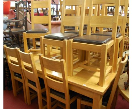 A contemporary light oak dining suite comprising; extending table with pull-out action and hinged fold-out leaf, and a set of