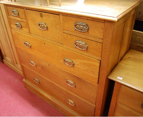 An Edwardian light oak square front chest of large proportions, having a central hat drawer flanked by four short drawers ove