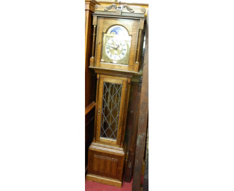 A late 20th century German oak cased longcase clock, having three train striking and chiming movement, with rolling moon dial