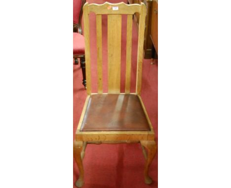 A set of four early 20th century light oak slatback dining chairs