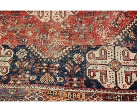A Persian woollen rust ground carpet, decorated with geometric motifs, 207 x 162cm