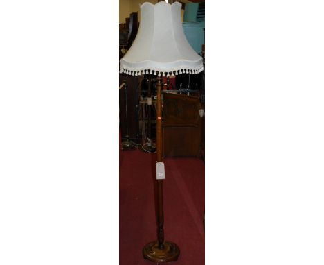 A turned beech standard lamp with shade