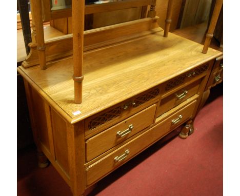 A mid 20th century light oak swing mirror backed dressing chest