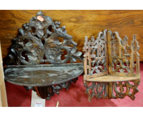 A floral carved and pierced hinged folding wall shelf and one other similar (2)