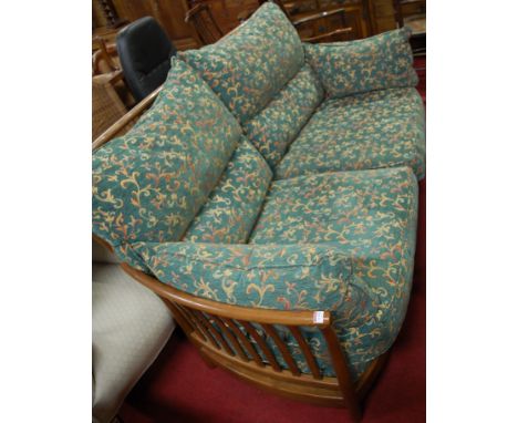 A contemporary Ercol mid-elm slatback three seater sofa, having floral upholstered cushions Condition Report / Extra Informat