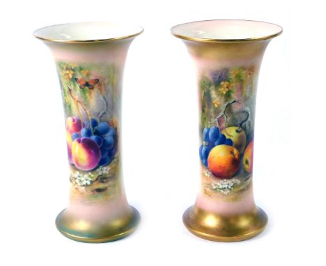 A pair of Royal Worcester porcelain vases, c1918, of trumpet form, painted by Ricketts, decorated with fruit, G923, printed m