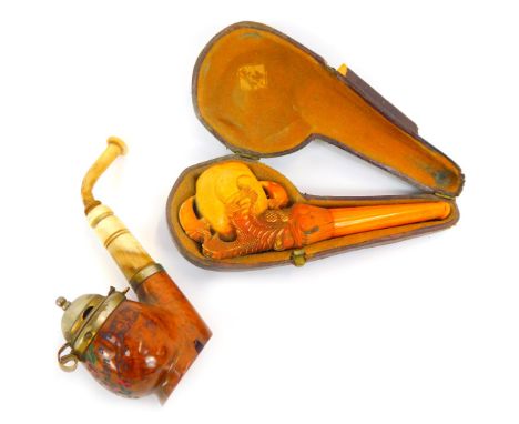 A late 19thC meerschaum pipe, with amber cheroot, modelled as a claw holding central bowl, in leather case, together with a f