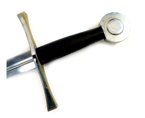 A reproduction medieval broad sword, with circular steel pommel, black leather hand grip and straight blade, with a steel and